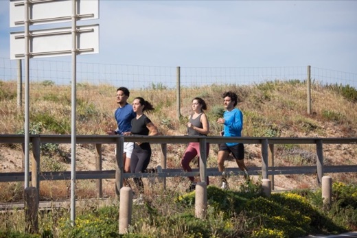 Group of friends jogging together on an outdoor trail