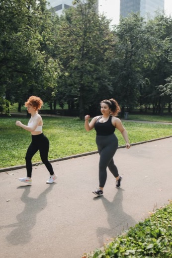 Two women walking briskly in a park